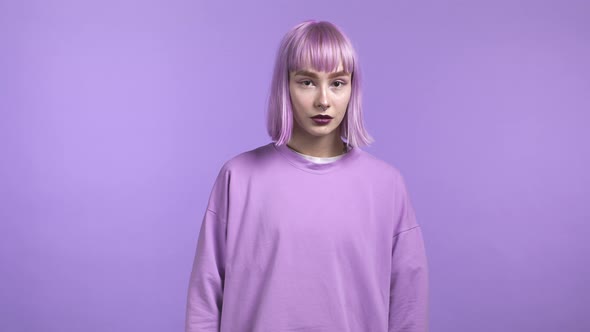 Portrait of Millenial Trendy Woman with Dyed Violet Hair on Purple Studio Background