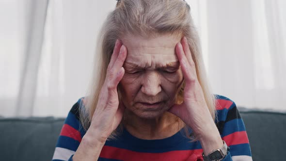 Old Lonely Woman Suffering From Headache