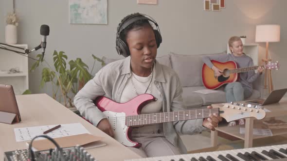 Black Woman Singing to Electric Guitar