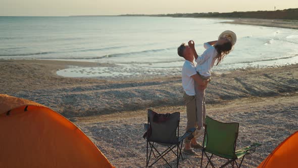 Lovely Man Picks Up Happy Laughing Woman and Kiss Her