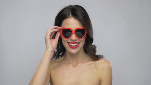 Woman with Red Lipstick and Heart Shaped Shades 