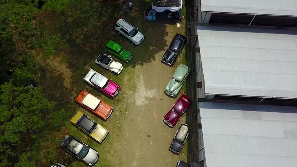 Colorful Collection of Antique Vintage Classic Cars Overhead Tilt Down Drone Shot