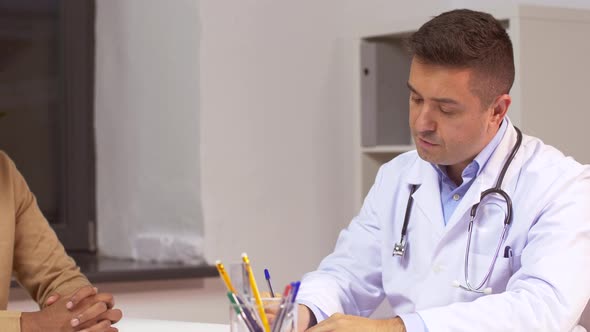 Male Doctor Giving Prescription To Patient 45