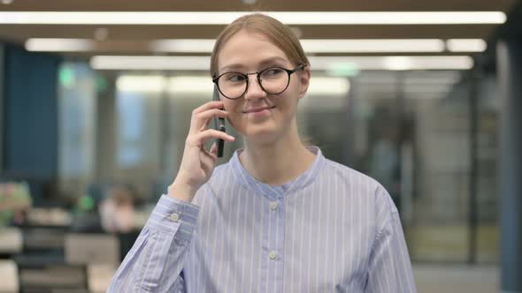 Portrait of Young Woman Talking on Smartphone