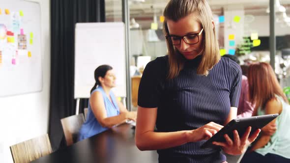 Business executive using mobile phone and digital tablet