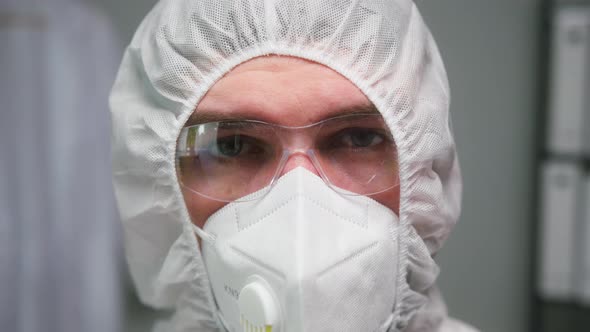 Closeup of Overworked Doctor or Researcher Dressed in Protective Suit Ppe Mask in Laboratory in