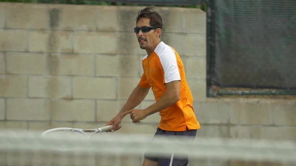 Tennis player practicing returning serves.