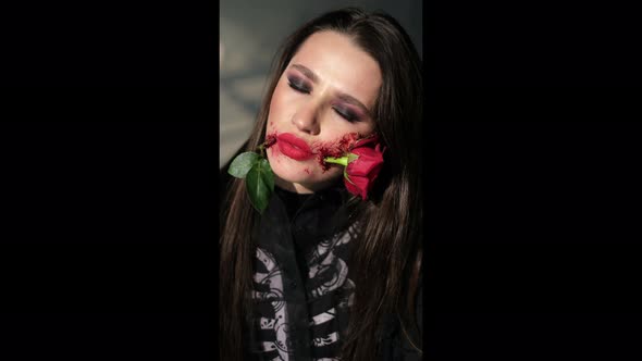 Portrait of a Passionate Professional Model with a Red Rose in Her Mouth