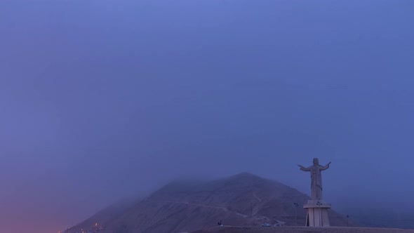 Aerial View of Cristo Del Pacifico and Morro Solar Hill in the Background Night to Day Timelapse