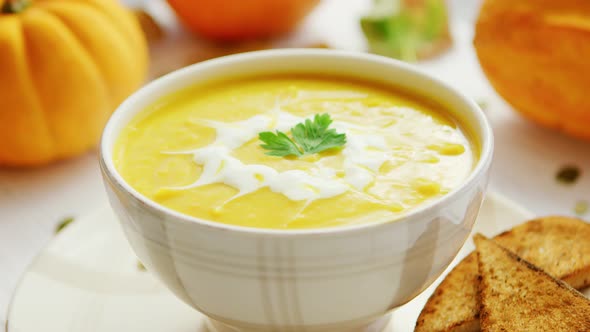 Pumpkin Soup in Bowl Served with Bread