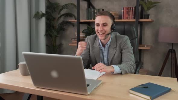 Happy Businessman Enjoying Good News Celebrating Success in Business Sitting at Desk in Office