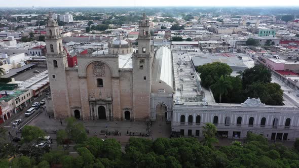 Aerial camera ascending and pitching down focussed on the Cathedral of Merida at the Grand Plaza in