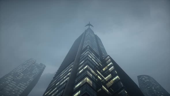 Airplane flying above high rise buildings and reflects on glass facade.