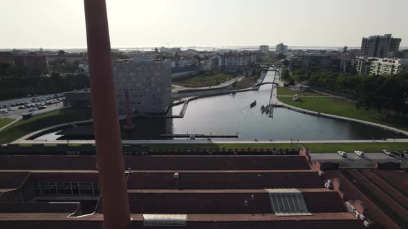 Fly over buildings approaching Ria de Aveiro romantic canals, also know as Portugal Venice.