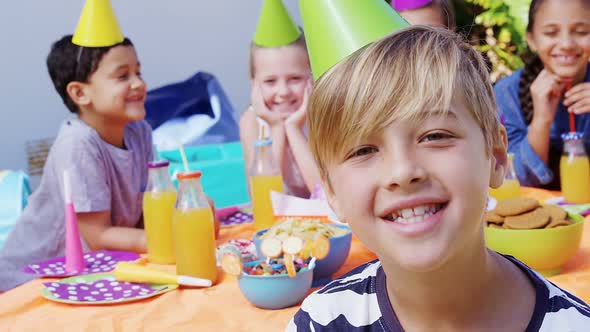 Boy sitting with the friends in the backyard of house 4k