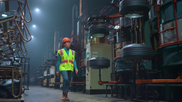 Focused Woman Supervisor Walking at Huge Modern Production Facility Warehouse