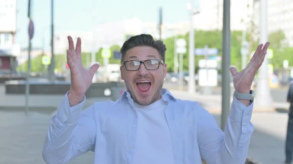 Portrait of Excited Man Celebrating Success Outdoor