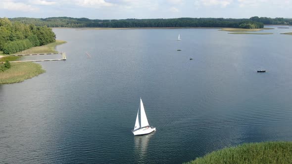 Aerial view of a sailboat on a lake in Masuria (Mazury) region in Poland, Europe