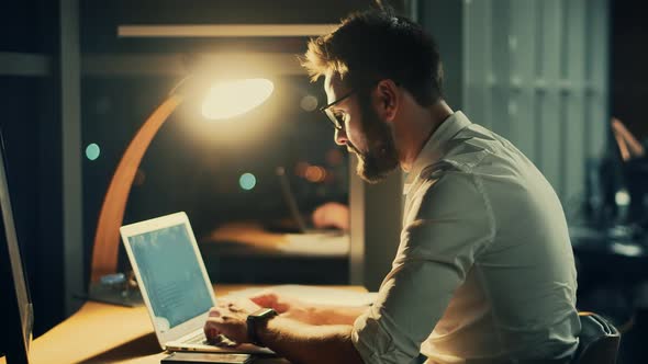 Tired Worker Overworked On Computer. Frustrated Businessman Working Alone. Office Work Overtime.