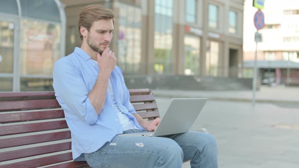 Thinking Man Using Laptop While Sitting Outdoor on Bench