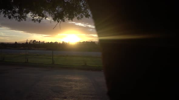 Slowmotion Reveal of a Beautiful Sunset in Africa with an Empty Road in foreground