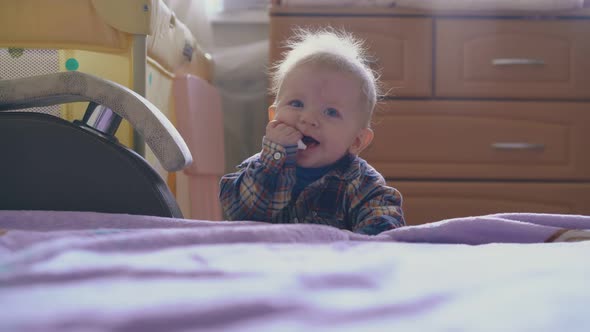 Funny Boy in Warm Shirt Plays with Plastic Tube at Bed
