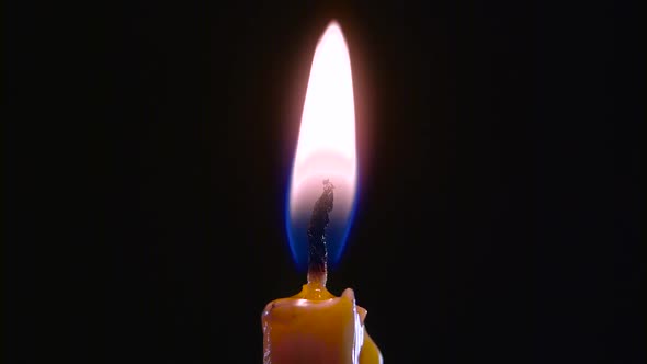 Candle Is on and Goes Out. Black Background. Close Up