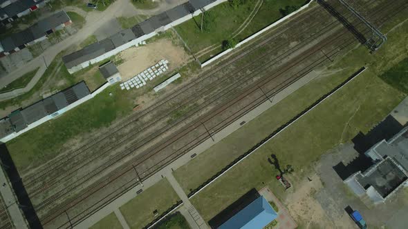 Flight Over Suburban Railway Station. Railroad Tracks And Sleepers Are Visible.