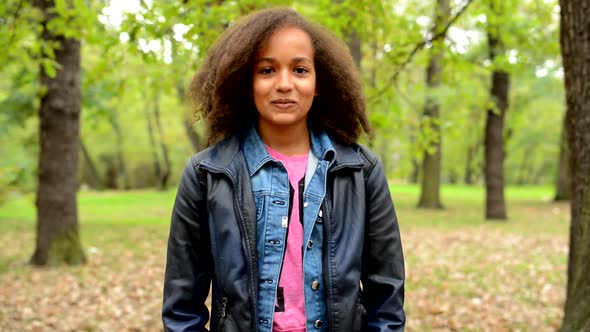 Young African Happy Girl with Fluffy Hair Shows Thumbs Up As Agree - Eye Contact