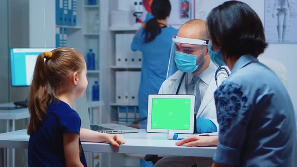 Doctor Holding Green Screen Tablet