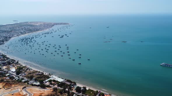 Aerial pan left shot of Mui ne coastline in sunny day, Vietnam