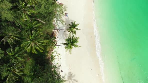 Luxury above island view of a white sandy paradise beach and blue sea background in high resolution 