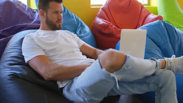 Young caucasian male executive working on laptop in modern office 4k