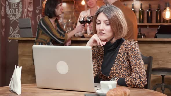 Woman Reading Very Careful and Focused an Important Message at Her Laptop