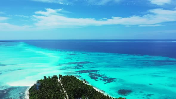 Aerial above scenery of relaxing shore beach break by aqua blue ocean with white sand background of 