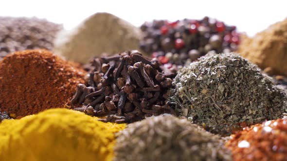 Different Spices and Aromatic Herbs Laid Out on a White Background