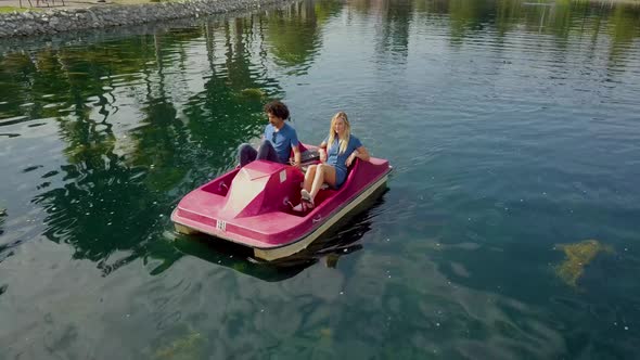 Cute Couple Enjoying A Boat Ride In The Park
