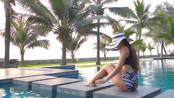 Young asian woman enjoy around outdoor swimming pool for leisure