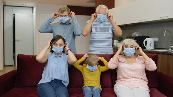 Coronavirus Quarantine Lockdown Concept. Family Puts Medical Protective Masks on Faces at Home