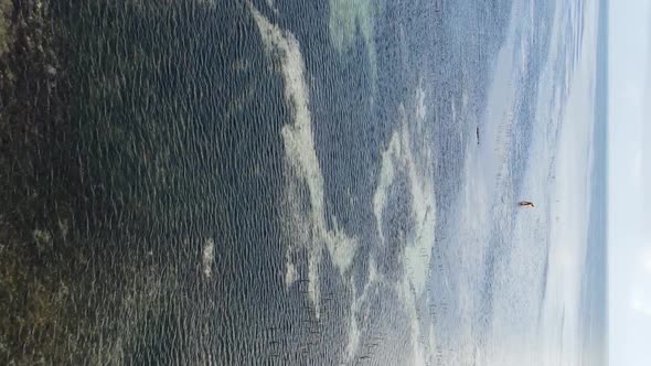 Vertical Video of Low Tide in the Ocean Near the Coast of Zanzibar Tanzania Aerial View