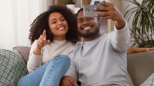 Happy Couple with Smartphone Taking Selfie at Home