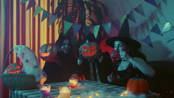 A Group of Friends Celebrating Halloween Laughing and Chatting Together