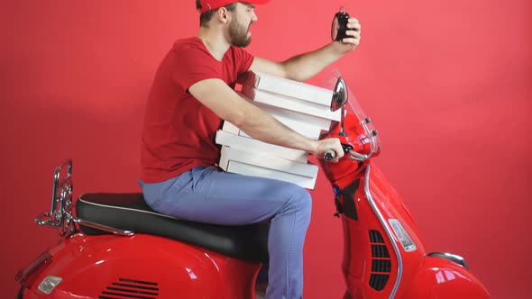 Advertising Concept Beautiful Courier Guy on a Motorcycle Scooter in a Hurry To Deliver Orders in