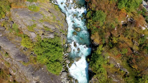 Flying over a beautiful river running through a forest