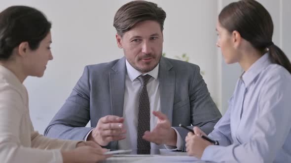 Male and Female Business Person having Cheerful Conversation in Office