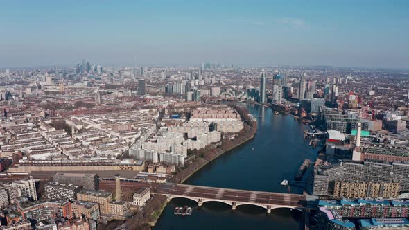 Super high rising aerial drone shot of London from the west sunny day