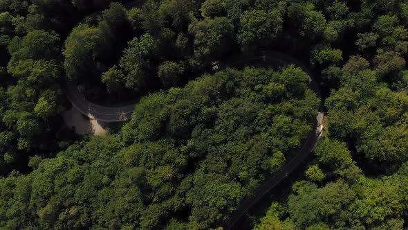 Aerial look up shot from a green forest up to a idyllic placed monastery in southern bavaria.