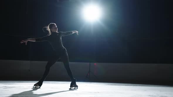 Professional Female Ice Figure Skater Practicing Spin on Indoor Skating Rink Shot on 120 FPS Slow