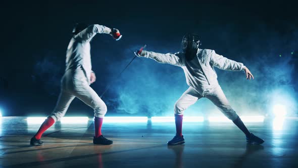 Athletes are Practicing Fencing Attack Strategies