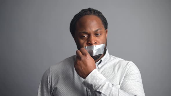 AfricanAmerican Guy Sealed Mouth Isolated on Grey Background